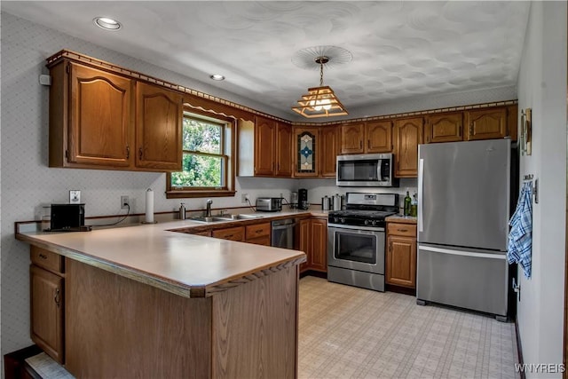 3851 Upper Mountain Rd, Cambria, NY 14132 - kitchen featuring stainless steel appliances, a peninsula, brown cabinets, decorative light fixtures, and recessed lighting