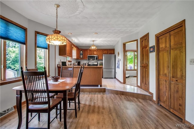 3851 Upper Mountain Rd, Cambria, NY 14132 - dining room with plenty of natural light, light wood-style flooring, and a textured ceiling