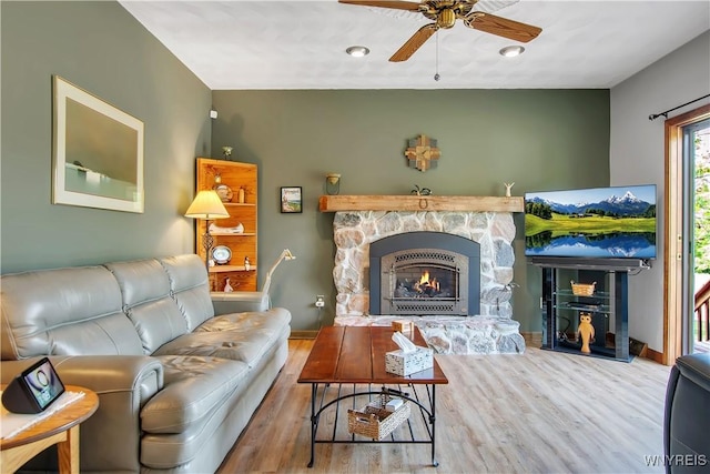 3851 Upper Mountain Rd, Cambria, NY 14132 - living room featuring wood finished floors, a ceiling fan, and a fireplace