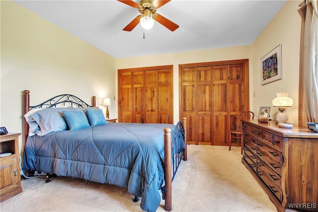 3851 Upper Mountain Rd, Cambria, NY 14132 - bedroom featuring light colored carpet, two closets, and a ceiling fan