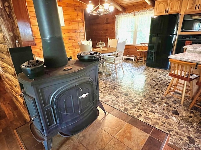 13 Popple Hill Rd, Fowler, NY 13642 - kitchen featuring black appliances, a wood stove, wood walls, and a chandelier