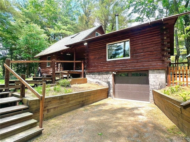 13 Popple Hill Rd, Fowler, NY 13642 - view of property exterior with log exterior, asphalt driveway, a garage, and stairway