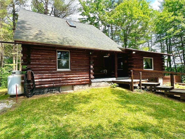 13 Popple Hill Rd, Fowler, NY 13642 - rear view of house with log siding, a shingled roof, a wooden deck, and a lawn