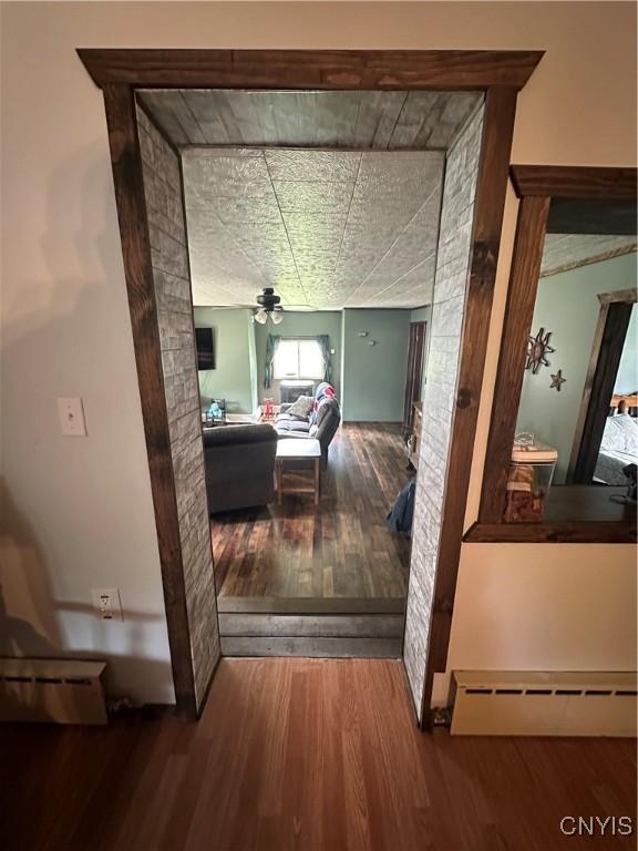 14309 Pearl St, Diana, NY 13648 - corridor featuring wood-type flooring and a baseboard radiator