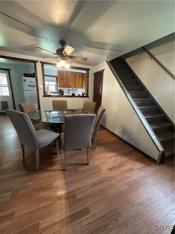 14309 Pearl St, Diana, NY 13648 - dining space with wood finished floors, ceiling fan, and stairs