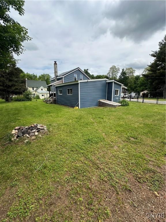 14309 Pearl St, Diana, NY 13648 - back of house featuring a chimney and a lawn