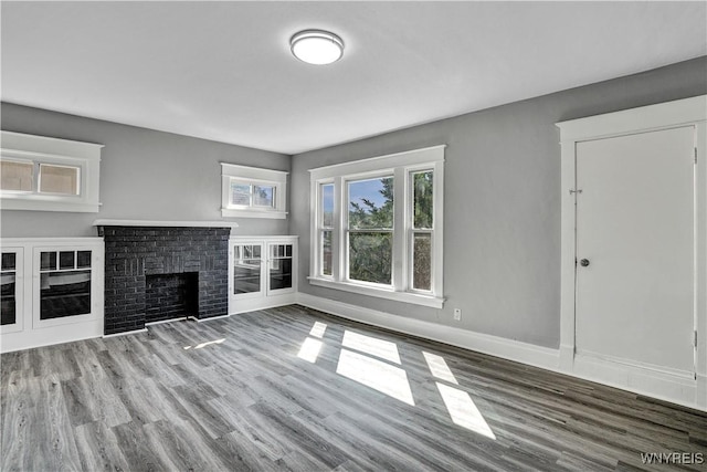 110 Weyand Ave, Buffalo, NY 14210 - unfurnished living room featuring wood finished floors and a brick fireplace