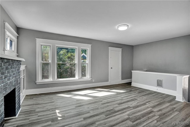 110 Weyand Ave, Buffalo, NY 14210 - unfurnished living room featuring a brick fireplace and wood finished floors