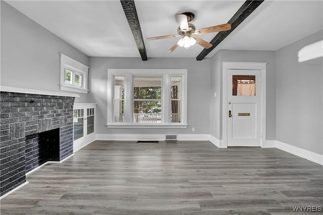 110 Weyand Ave, Buffalo, NY 14210 - unfurnished living room featuring plenty of natural light, beamed ceiling, a ceiling fan, a brick fireplace, and wood finished floors