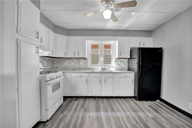 110 Weyand Ave, Buffalo, NY 14210 - kitchen with white range with gas cooktop, freestanding refrigerator, a paneled ceiling, a ceiling fan, and light countertops
