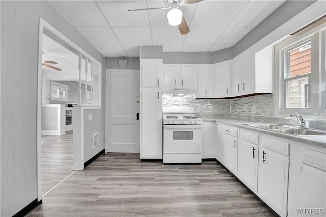 110 Weyand Ave, Buffalo, NY 14210 - kitchen with white range with gas cooktop, ceiling fan, light countertops, white cabinets, and a drop ceiling