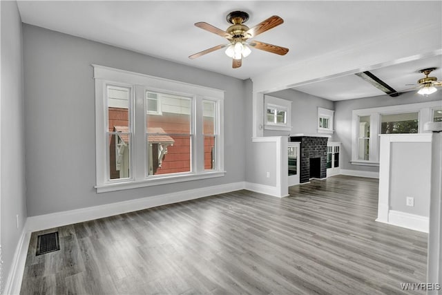 110 Weyand Ave, Buffalo, NY 14210 - unfurnished living room with ceiling fan, wood finished floors, a brick fireplace, and beam ceiling