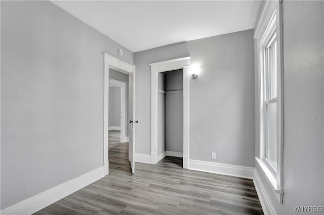 110 Weyand Ave, Buffalo, NY 14210 - unfurnished bedroom featuring wood finished floors, a closet, and multiple windows