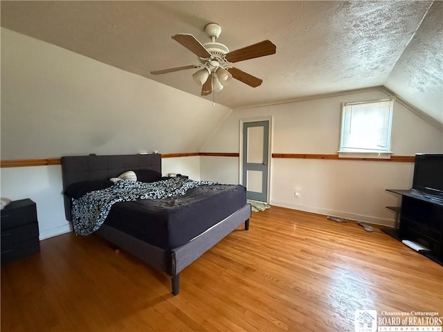 67 Harriet St, Allegany, NY 14706 - bedroom with lofted ceiling, wood finished floors, ceiling fan, and a textured ceiling