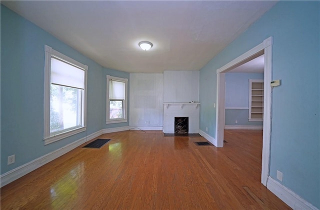 362 Euclid Ave, Elmira-City, NY 14905 - unfurnished living room with a fireplace with flush hearth and wood finished floors