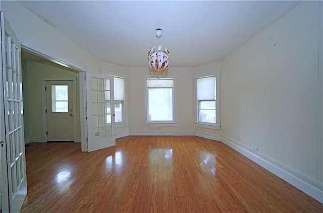 362 Euclid Ave, Elmira-City, NY 14905 - unfurnished dining area with wood finished floors, a chandelier, and healthy amount of natural light