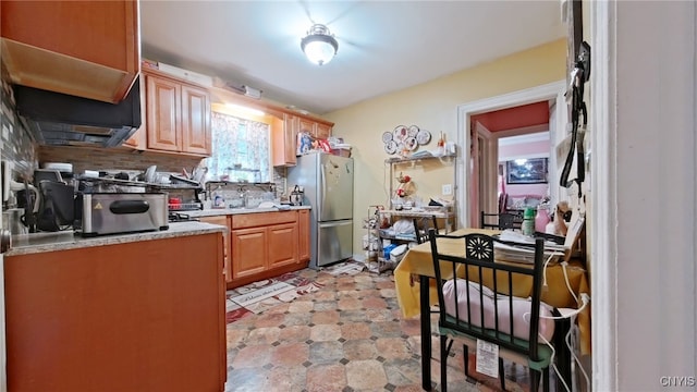 900 Sherman Pl, Utica, NY 13502 - kitchen with freestanding refrigerator, backsplash, and light countertops