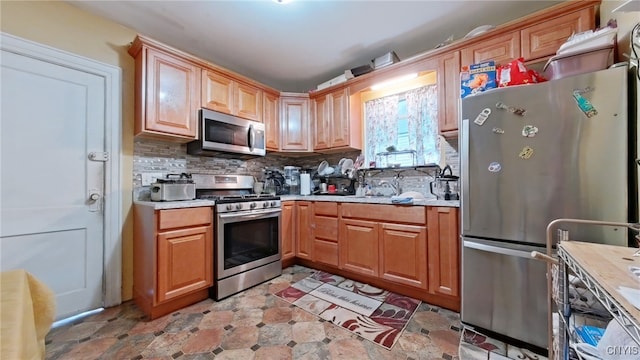 900 Sherman Pl, Utica, NY 13502 - kitchen with stainless steel appliances, light countertops, and tasteful backsplash