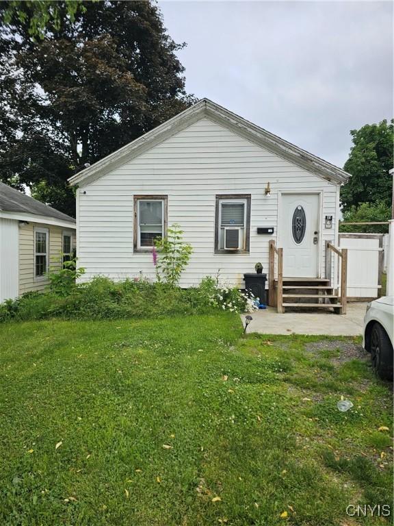 6 Bryant St, Utica, NY 13502 - view of front of house with a front yard, entry steps, and cooling unit
