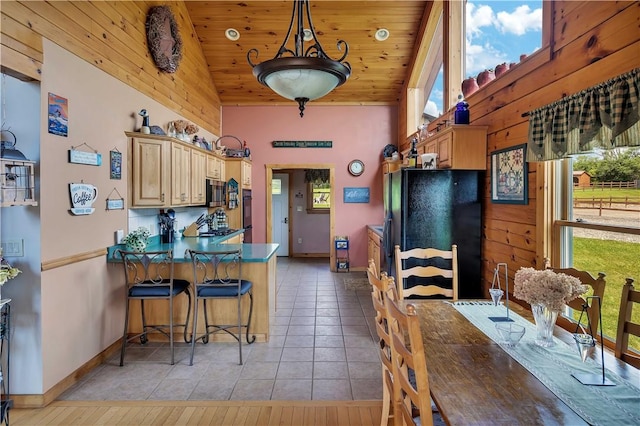 5600 State Route 81, Greenville, NY 12083 - kitchen featuring freestanding refrigerator, a peninsula, wood ceiling, stainless steel microwave, and light tile patterned floors