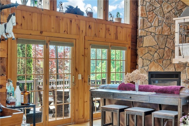 5600 State Route 81, Greenville, NY 12083 - entryway featuring wood walls, a stone fireplace, a towering ceiling, and wood finished floors