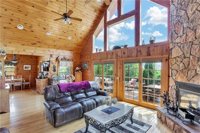 5600 State Route 81, Greenville, NY 12083 - living room featuring plenty of natural light, high vaulted ceiling, wooden walls, ceiling fan, and light wood-style flooring