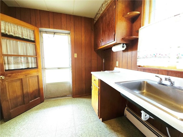 4883 Pinecrest Rd, Veteran, NY 14864 - kitchen with wooden walls, open shelves, light countertops, light flooring, and brown cabinets