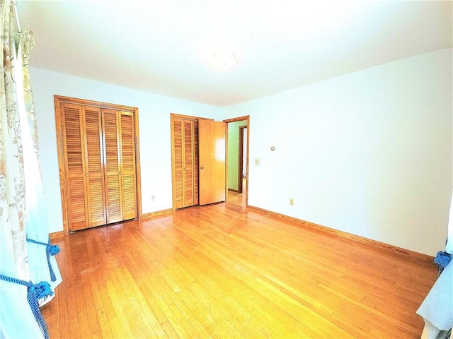4883 Pinecrest Rd, Veteran, NY 14864 - unfurnished bedroom with multiple closets and light wood-type flooring
