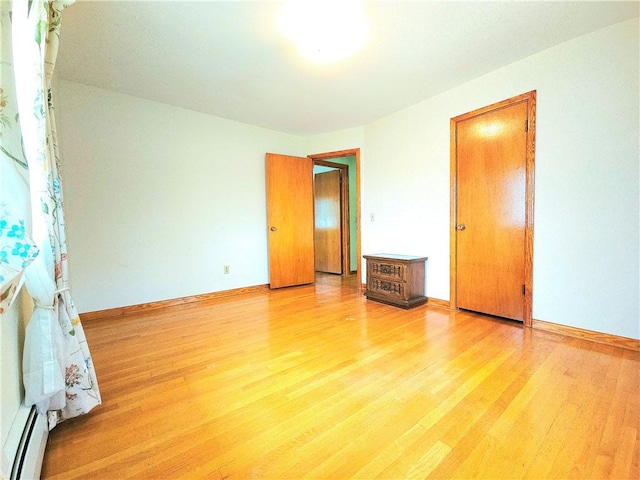 4883 Pinecrest Rd, Veteran, NY 14864 - unfurnished bedroom featuring light wood-type flooring and a baseboard radiator