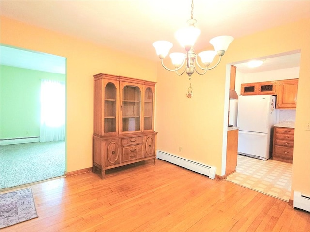 4883 Pinecrest Rd, Veteran, NY 14864 - unfurnished dining area featuring a baseboard heating unit, a chandelier, and light wood-style flooring