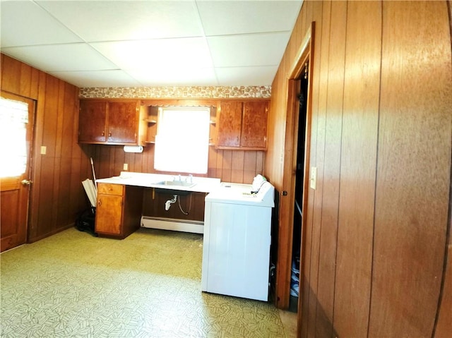 4883 Pinecrest Rd, Veteran, NY 14864 - laundry room with a baseboard radiator, washer / dryer, wooden walls, light flooring, and a desk