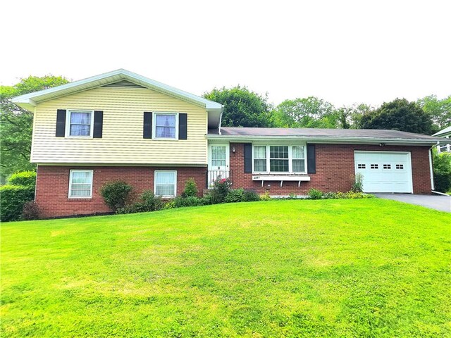 4883 Pinecrest Rd, Veteran, NY 14864 - tri-level home with a garage, brick siding, a front lawn, and asphalt driveway