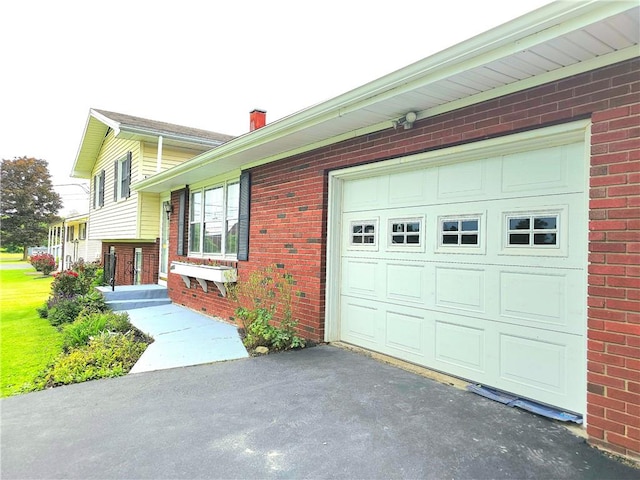 4883 Pinecrest Rd, Veteran, NY 14864 - view of front facade featuring brick siding, asphalt driveway, a chimney, and an attached garage
