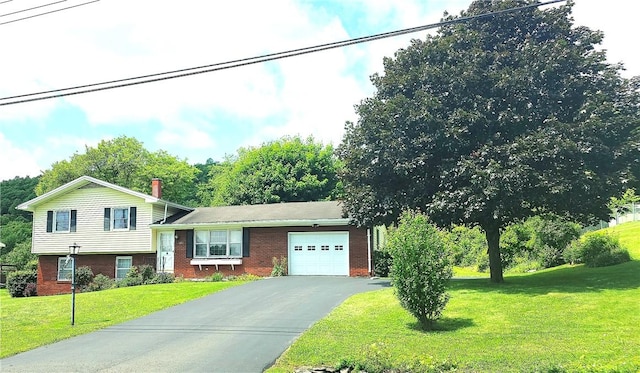 4883 Pinecrest Rd, Veteran, NY 14864 - view of front of house featuring an attached garage, brick siding, asphalt driveway, and a front lawn