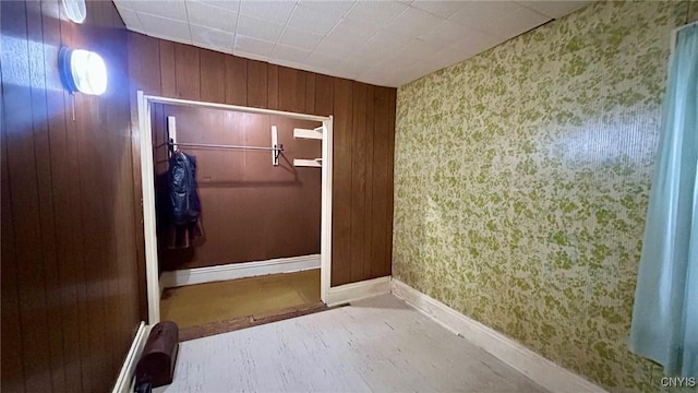 318 Boyden St, Syracuse, NY 13203 - unfurnished bedroom with wallpapered walls, a closet, and wood walls