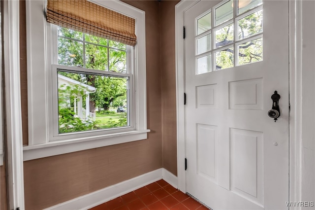 87 Garrison Rd, Amherst, NY 14221 - doorway featuring healthy amount of natural light and dark tile patterned floors