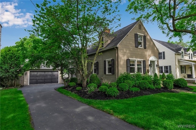 87 Garrison Rd, Amherst, NY 14221 - view of front of property with a detached garage, a chimney, and a front yard