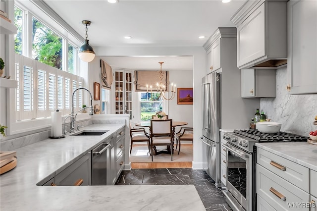 87 Garrison Rd, Amherst, NY 14221 - kitchen featuring stainless steel appliances, dark marble finish floors, recessed lighting, a chandelier, and backsplash
