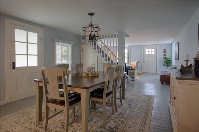 7689 State Highway 80, Springfield, NY 13468 - dining space featuring stairs, a chandelier, and wood-type flooring