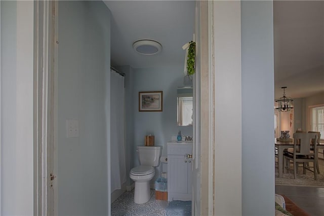 7689 State Highway 80, Springfield, NY 13468 - bathroom with vanity, a shower with shower curtain, and a chandelier