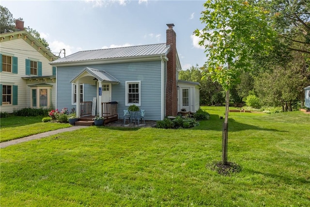 7689 State Highway 80, Springfield, NY 13468 - view of front of house with a front yard, a chimney, and a metal roof