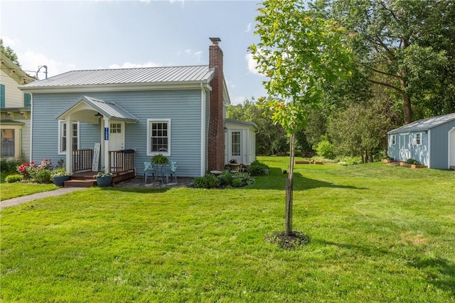 7689 State Highway 80, Springfield, NY 13468 - view of front facade with a front lawn, a chimney, and a metal roof