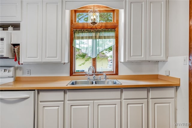 3317 D St, Niagara Falls, NY 14303 - kitchen featuring white cabinetry, white appliances, and light countertops