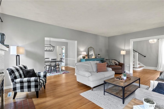 552 Locust St, Lockport-City, NY 14094 - living area featuring a chandelier, wood finished floors, and stairway