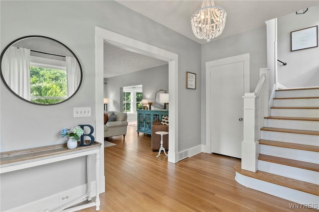 552 Locust St, Lockport-City, NY 14094 - entrance foyer featuring healthy amount of natural light, light wood-style floors, a chandelier, and stairs