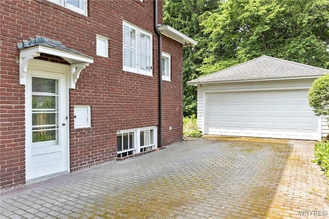 552 Locust St, Lockport-City, NY 14094 - view of side of home featuring brick siding, a garage, and an outbuilding