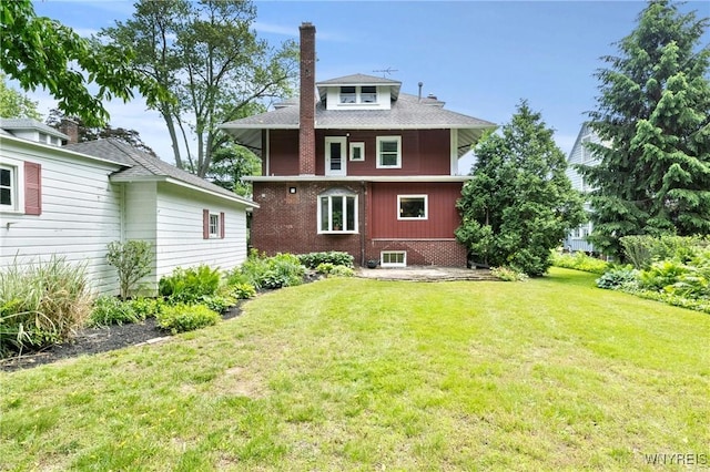 552 Locust St, Lockport-City, NY 14094 - rear view of property featuring a yard, a chimney, and brick siding
