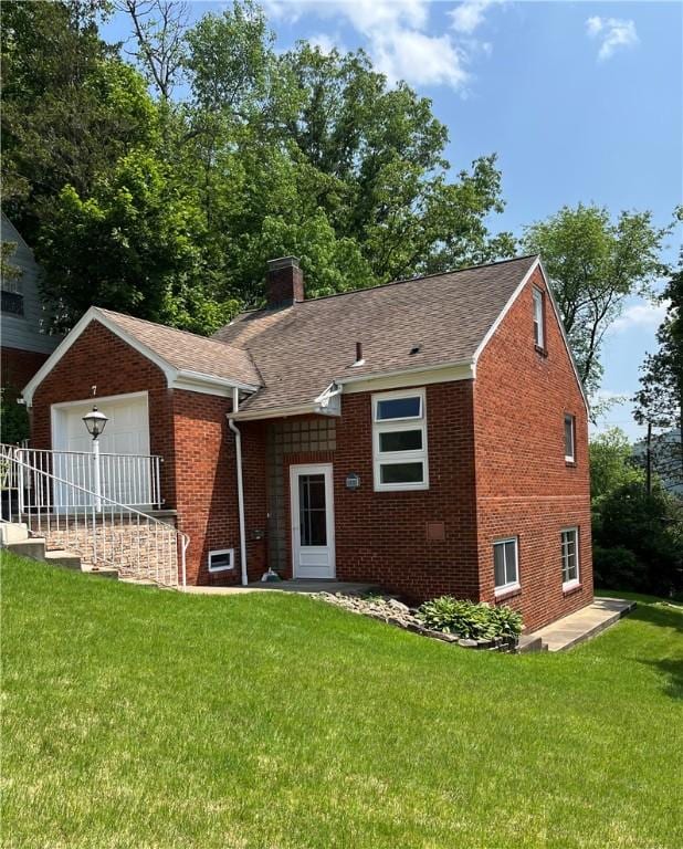 7 Orchard Pl, Bradford-City, PA 16701 - view of front of property with a chimney, brick siding, and a front yard