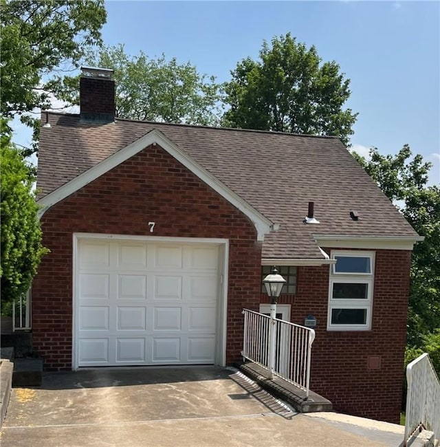 7 Orchard Pl, Bradford-City, PA 16701 - view of front facade with brick siding, concrete driveway, a chimney, and a shingled roof