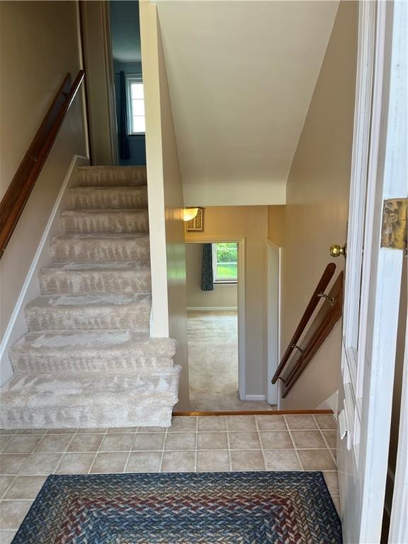 7 Orchard Pl, Bradford-City, PA 16701 - staircase featuring plenty of natural light, tile patterned floors, and vaulted ceiling
